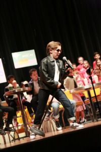 Boy singing in microphone during performance