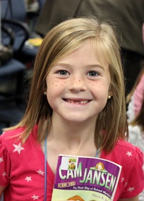 Girl with book in library